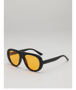 Detail view of oversized retro aviator sunglasses with black frame and yellow lenses