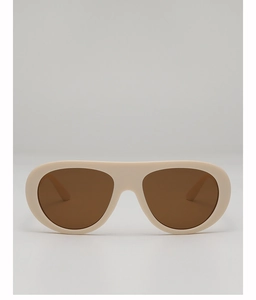 Close-up of beige aviator sunglasses with brown lenses and thick frames in a modern style