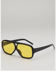 Detail view of vintage pilot sunglasses with bold black frames and yellow tinted lenses