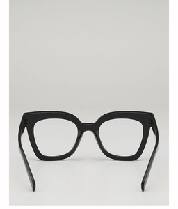 Detail of thick black square glasses frame showing the hinge and glossy finish