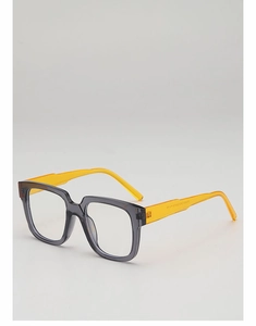 Macro shot of stylish square eyeglass frames with transparent gray front and yellow arms