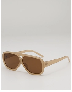 Detail view of vintage double-bridge sunglasses with translucent beige frames and brown lenses