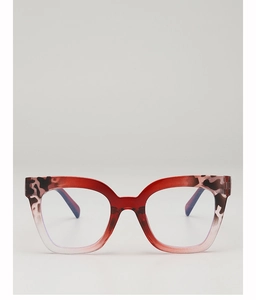 Close-up of cat-eye glasses frames with red gradient and tortoise leopard patterns