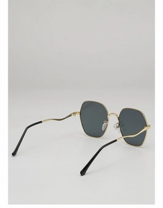 Detail of geometric metal frame sunglasses showing thin gold wave temples and dark lenses