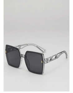 Vue détaillée de lunettes de soleil grises avec branches décoratives en métal ajouré