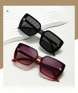 Detail of square sunglasses with golden palm tree ornaments on the frame temples