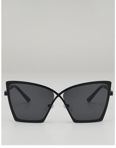 Close-up of black oversized cat-eye sunglasses with unique criss-cross bridge design