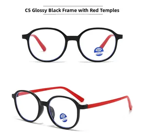 Detail view of round glasses frames in glossy black with contrasting red temples