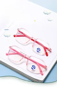 Detail view of pink and red square frame anti-blue light glasses for kids on a blue base
