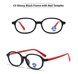 Detail of candy-colored oval blue light blocking glasses with black frame and red temples