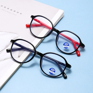 Kids round blue light blocking glasses in black and red jelly frames shown in a top view