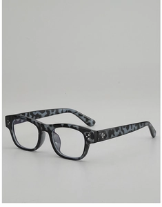Close-up of black marble pattern eyeglass frame with stylish three-dot rivet detail