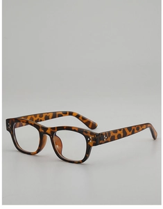 Detailed close-up of retro tortoiseshell square glasses frame with silver rivet accents