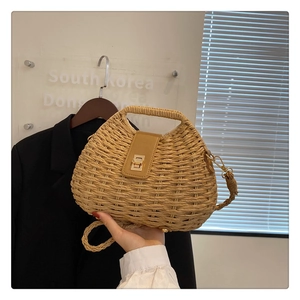 Minimalist straw woven crossbody bag with brown leather flap and golden buckle detail