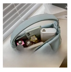 Detail presentation showing large storage capacity for essentials in light blue handbag