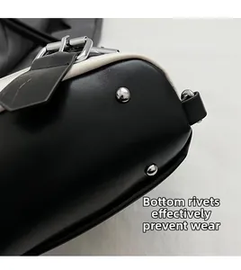 Detailed macro view of black leather handbag bottom with protective silver metal studs