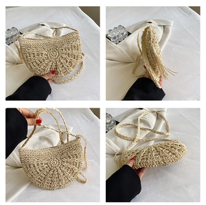 Detail of handmade straw half-moon bag featuring radial weaving and long side tassels
