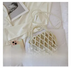 Detail of beaded pearl handbag showing woven structure and drawstring inner pouch