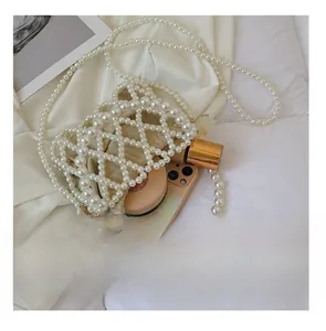Interior capacity of handmade pearl beaded bag showing phone and cosmetics