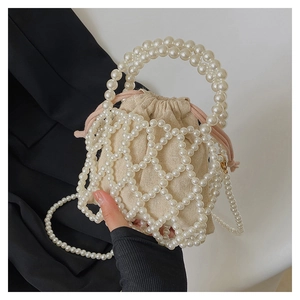 Detail of handmade beaded pearl handbag with cream drawstring liner and pearl strap