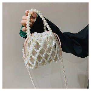 Close-up of handmade beaded pearl crossbody bag with linen drawstring lining