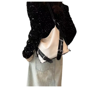 Stylish off-white leather shoulder bag with black straps and silver buckle details