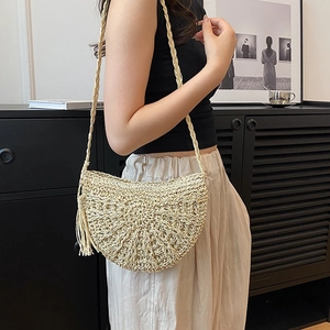 Bohemian beige woven half-moon crossbody bag with tassel and braided shoulder strap