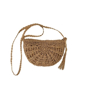 Handwoven straw crossbody bag with half-moon shape and tassel detail for summer vacation