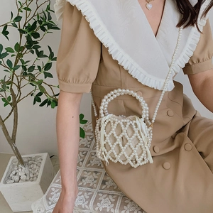 Elegant beaded pearl handbag with woven mesh structure and a drawstring inner pouch