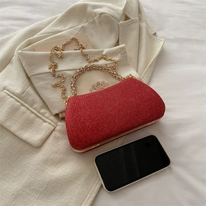 Detail of red sequin evening clutch bag with crystal crown clasp and diamond handle