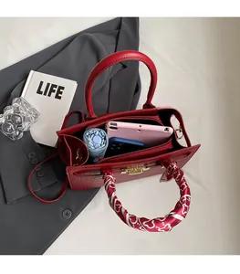 Interior view of a red crocodile pattern handbag showing large capacity for daily items