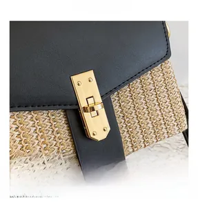 Detailed close-up of a golden metal twist lock on a woven and leather shoulder bag