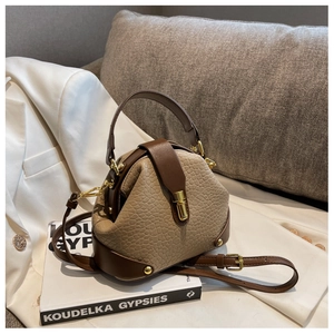 Retro patchwork doctor style handbag with beige grain texture and brown leather accents