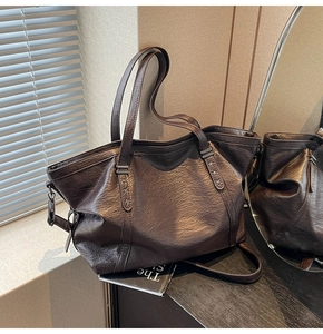 Détail du sac cabas en cuir marron foncé avec rivets étoiles et finition vintage