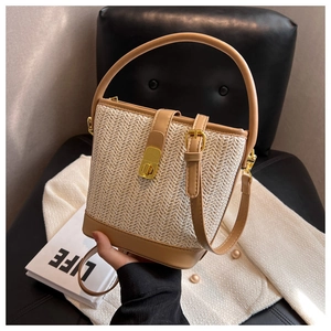 Woven straw bucket bag with leather trim and gold buckle for casual summer styling