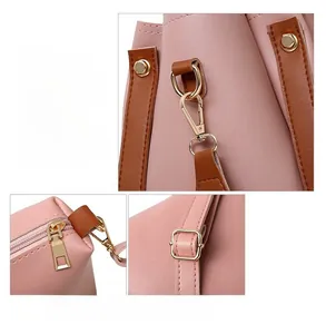 Détails du sac à main en cuir rose avec ferrures dorées et bordures marron élégantes
