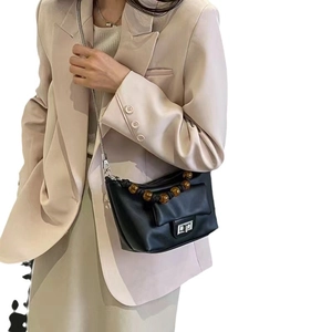 Chic black beaded handle trapezoid crossbody bag with silver clasp and chain strap