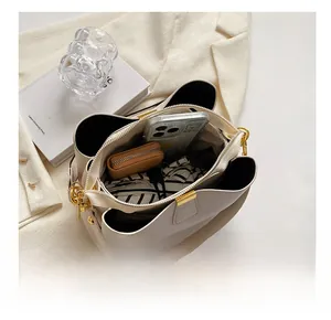 Internal view of beige lychee leather bag showing multiple compartments and large capacity