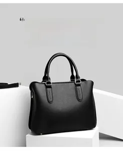 Close-up of black lychee grain texture and stitching on an elegant leather tote bag