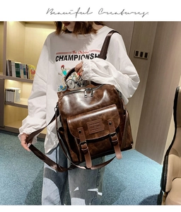 Close-up of vintage brown leather backpack texture with silver zipper and double buckle