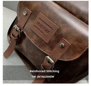 Detail of dark brown retro leather backpack with silver buckle and reinforced stitching