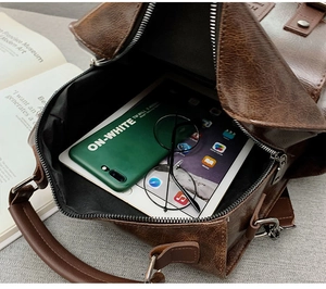 Interior view of large capacity dark brown oil wax leather bag with tablet and daily items
