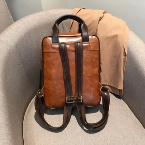 Detailed macro view of vintage brown leather handbag texture and reinforced stitching