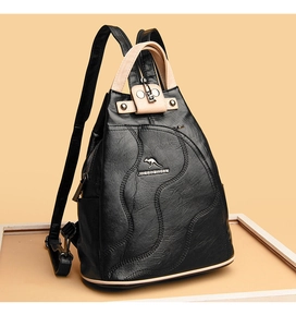 Detail of black lychee leather bag with kangaroo logo and beige handle contrast