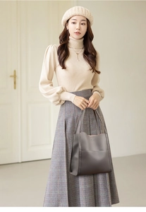 Detail of grey lychee leather tote bag worn with elegant urban commuter outfit