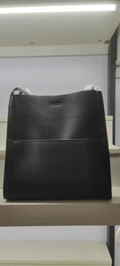 Detailed close-up of large black pebble-textured tote bag with elegant reinforced stitching