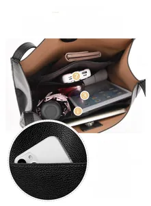 Detail view of black pebbled leather tote bag interior with multiple storage pockets