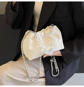 Detail of ruched cloud bag with silver chain strap and large frosted bead handle