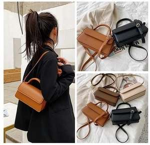 Detail showing various colors of the minimalist square crossbody bag with top handle