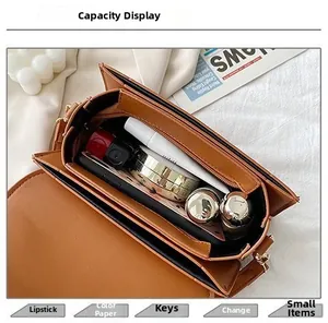 Internal capacity of the brown faux leather crossbody bag showing daily essentials inside